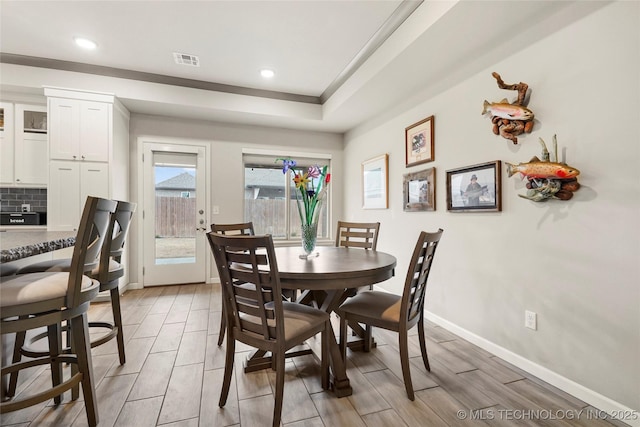 dining area featuring a raised ceiling