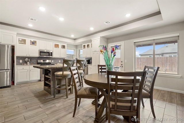 dining space with a tray ceiling