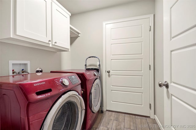 laundry area featuring cabinets and washer and dryer