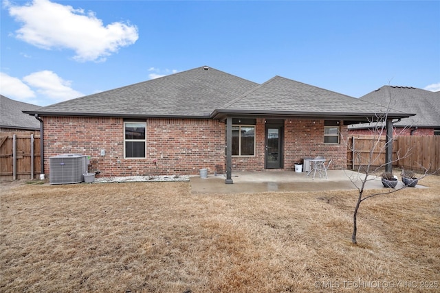 back of property featuring a lawn, a patio, and central air condition unit