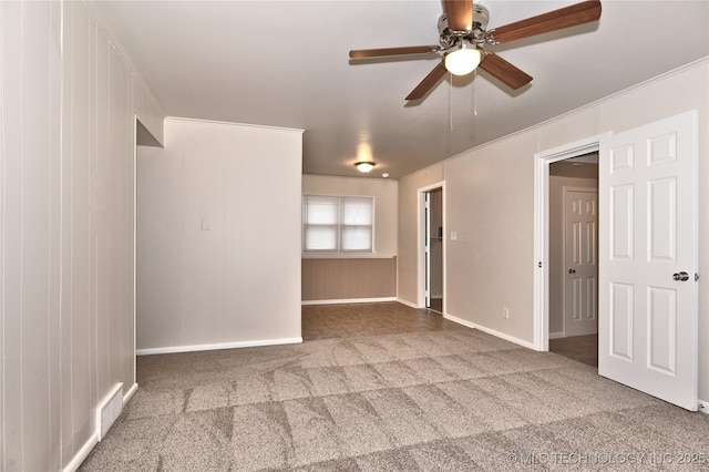 unfurnished room with ceiling fan and carpet floors