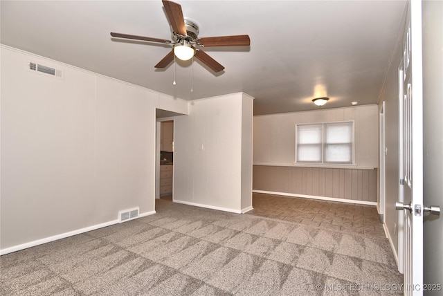 spare room with ceiling fan and carpet flooring