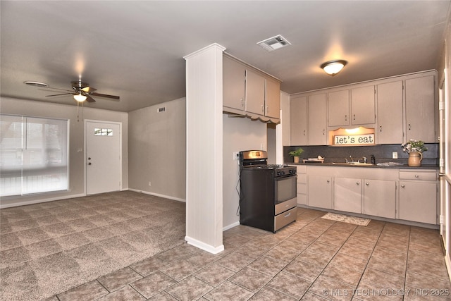 kitchen with sink, range with gas cooktop, ceiling fan, light colored carpet, and decorative backsplash