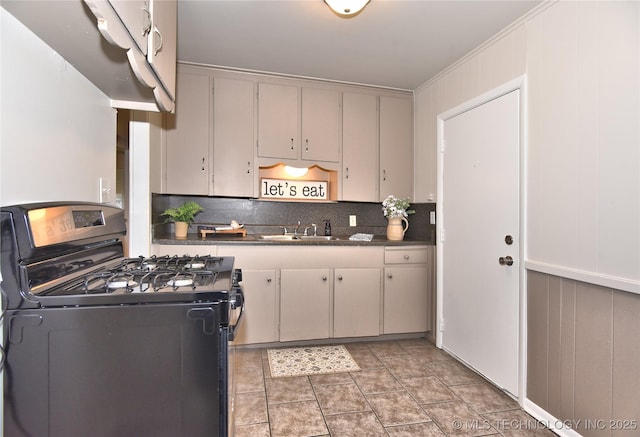 kitchen with light tile patterned floors, decorative backsplash, and range with gas stovetop