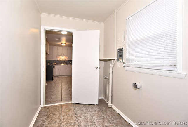 interior space featuring tile patterned floors and ornamental molding