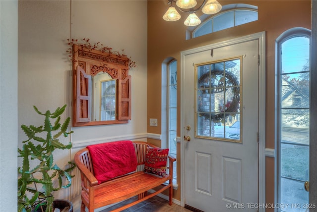 foyer entrance featuring a notable chandelier