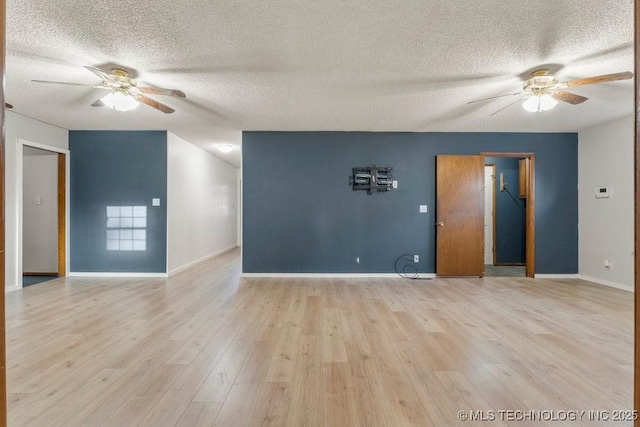 spare room with ceiling fan, a textured ceiling, and light wood-type flooring