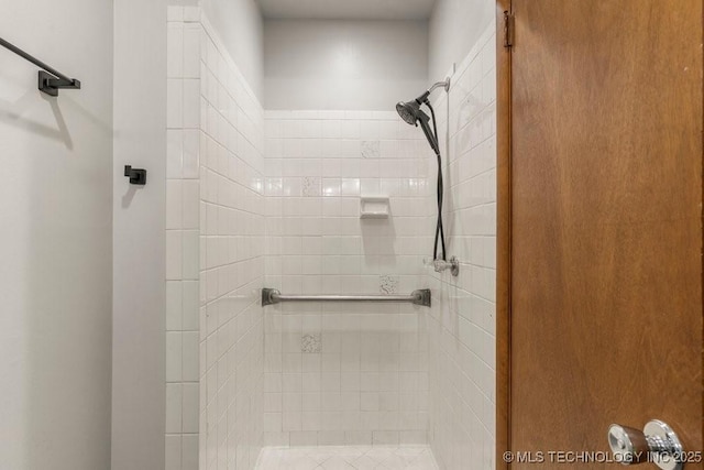 bathroom with tiled shower