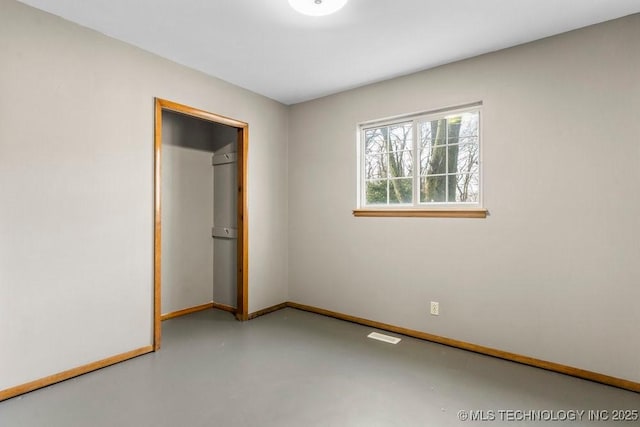 unfurnished bedroom featuring concrete flooring