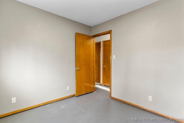 unfurnished room featuring concrete floors