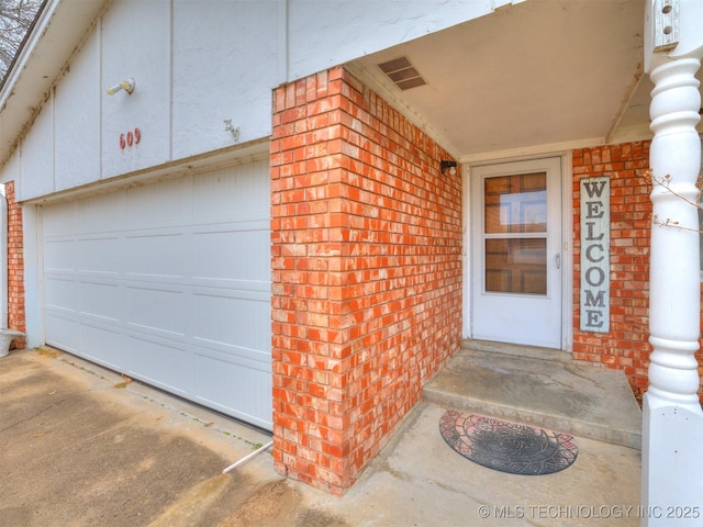 doorway to property with a garage