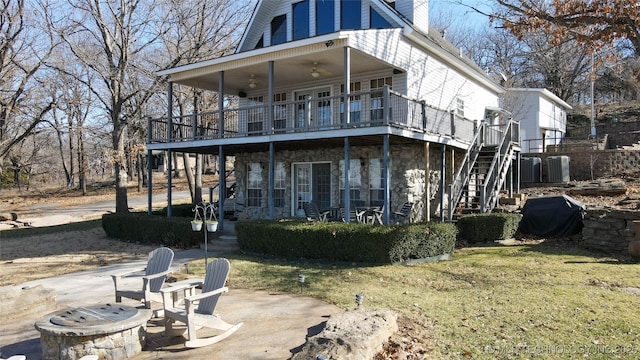 rear view of house featuring a patio, a deck, central AC unit, and a lawn