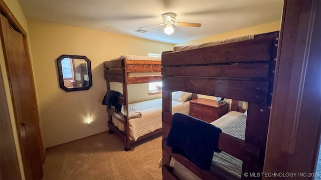 bedroom featuring light colored carpet and ceiling fan