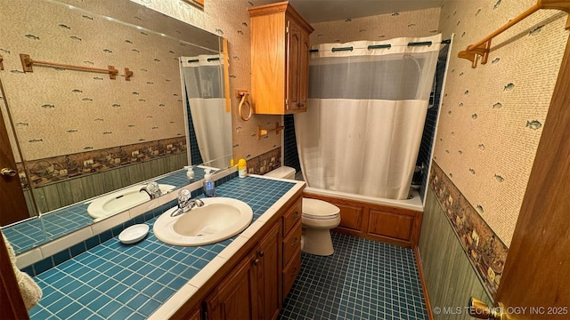 full bathroom featuring vanity, shower / bathtub combination with curtain, tile patterned floors, and toilet