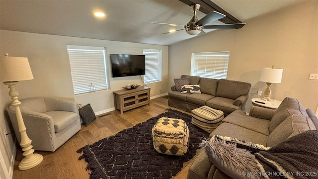 living room featuring lofted ceiling with beams, wood-type flooring, and ceiling fan