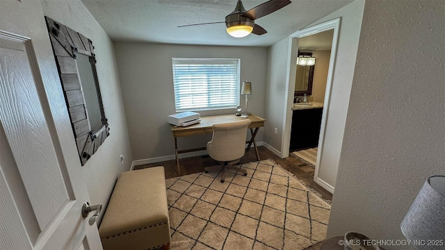 office space with a textured ceiling and ceiling fan