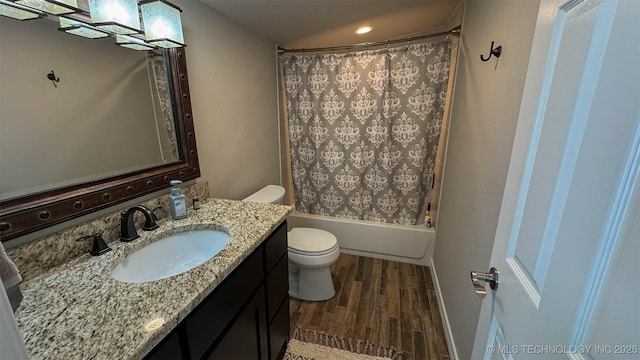 full bathroom with vanity, shower / tub combo, wood-type flooring, and toilet