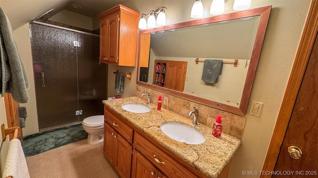 bathroom with tasteful backsplash, toilet, vanity, and a shower with shower door