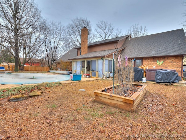 back of house featuring central AC, a patio area, and a covered pool