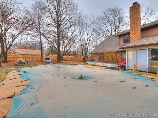 view of swimming pool featuring fence private yard