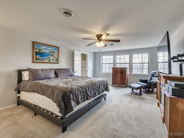 bedroom featuring baseboards, ceiling fan, visible vents, and light colored carpet