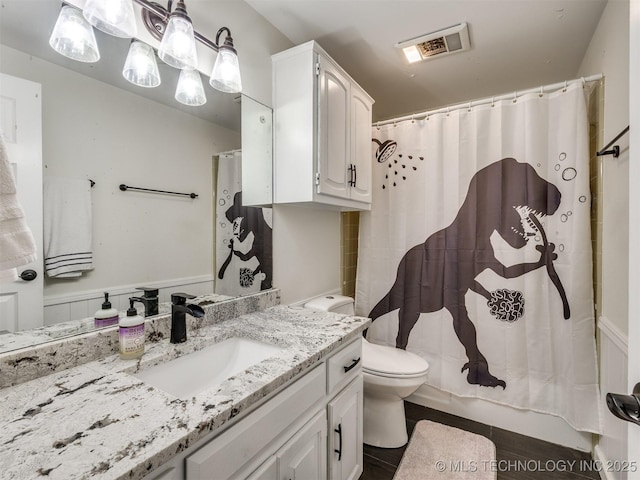 bathroom featuring vanity, a shower with shower curtain, and toilet