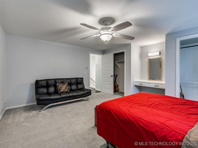 bedroom with light colored carpet, ceiling fan, baseboards, and two closets