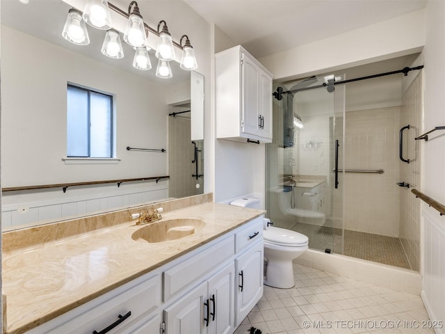 bathroom featuring vanity, tile patterned floors, a shower with door, and toilet