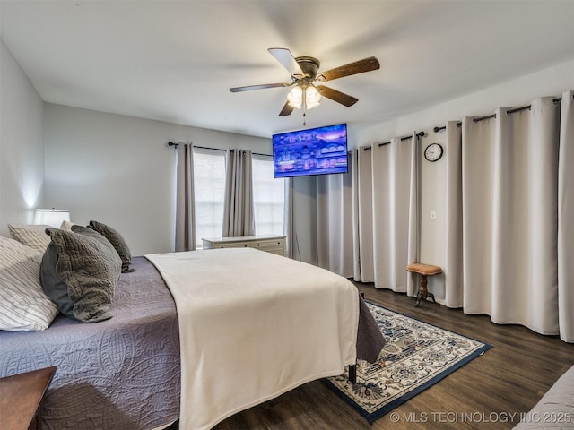 bedroom with dark hardwood / wood-style floors and ceiling fan