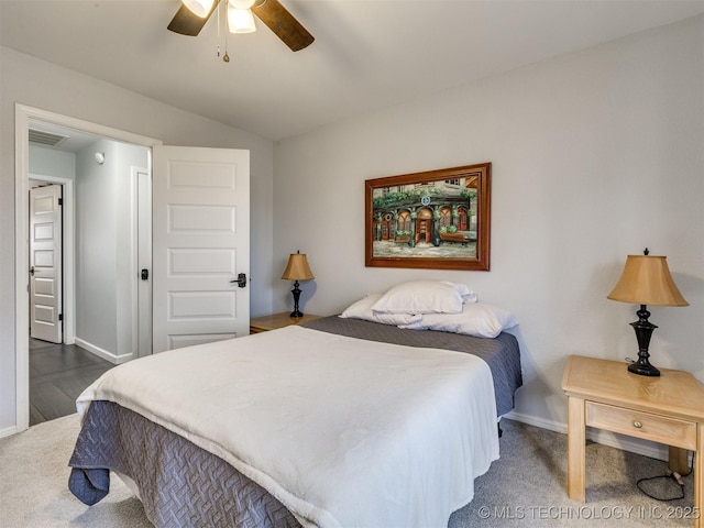 bedroom with visible vents, dark carpet, vaulted ceiling, ceiling fan, and baseboards