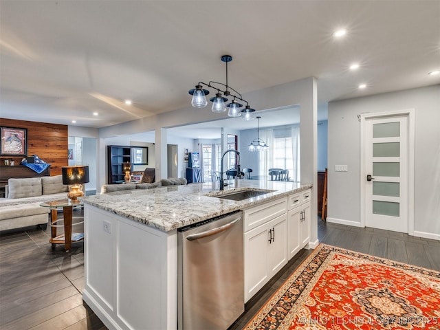 kitchen with sink, decorative light fixtures, a center island with sink, dishwasher, and white cabinets