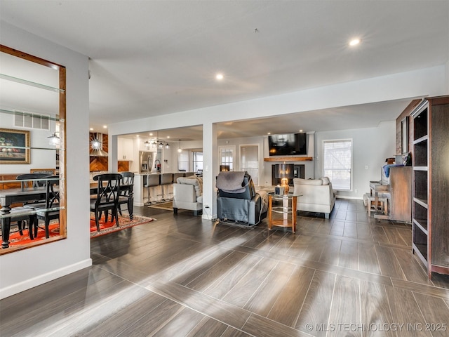 living area featuring baseboards and recessed lighting