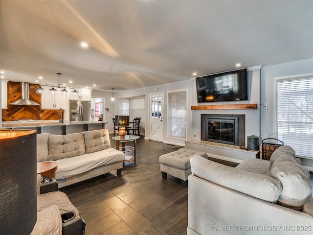 living room with sink, dark wood-type flooring, and a fireplace