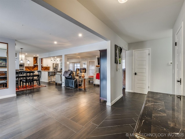 entryway with dark wood-type flooring, recessed lighting, and baseboards