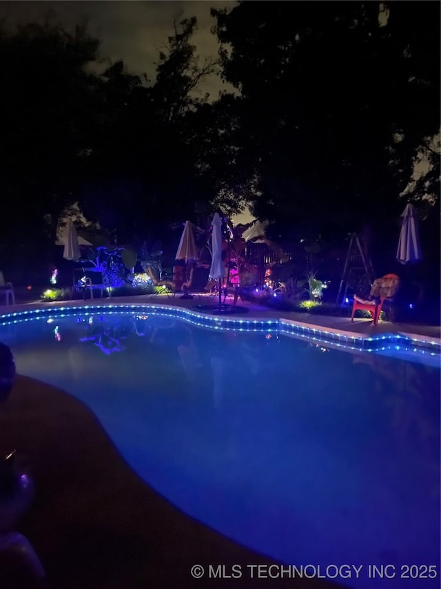 pool at twilight with an outdoor pool