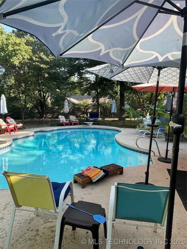 view of swimming pool with a fenced in pool, a patio area, and fence