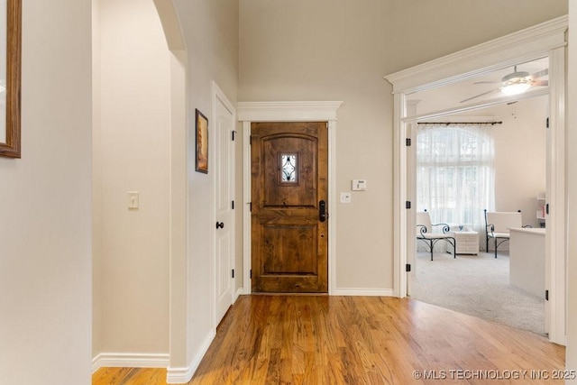 foyer with hardwood / wood-style floors and ceiling fan