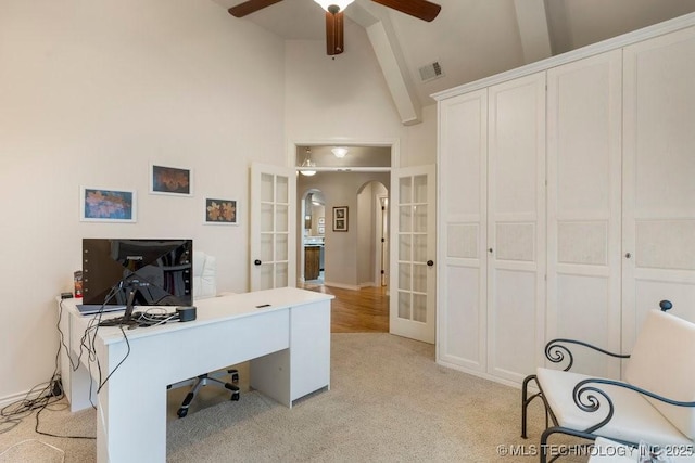 home office featuring ceiling fan, light colored carpet, high vaulted ceiling, and french doors