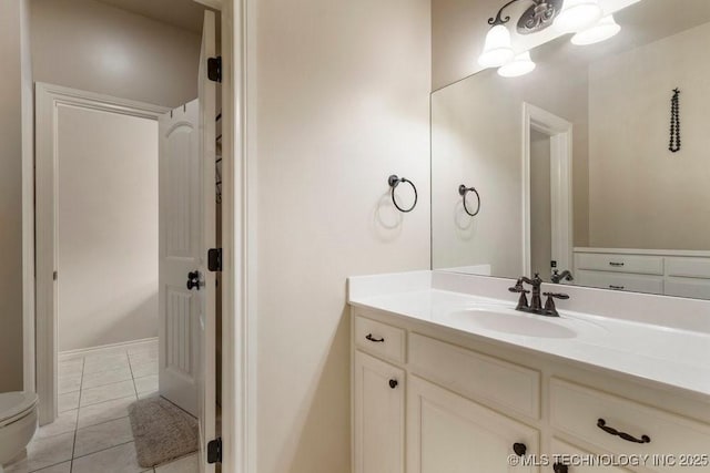 bathroom with vanity, tile patterned floors, and toilet