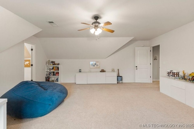 living area with ceiling fan, lofted ceiling, and light carpet