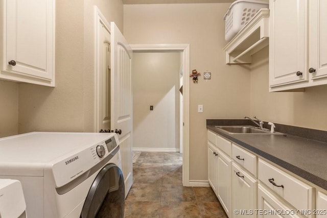 washroom featuring cabinets, sink, and independent washer and dryer