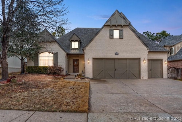 french country home featuring a garage