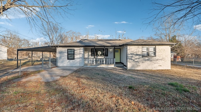 rear view of property featuring a carport, covered porch, and a lawn