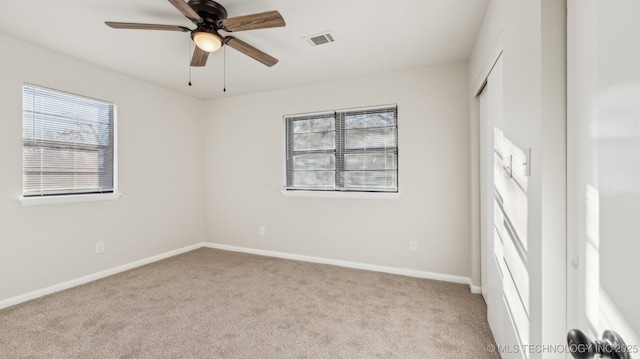 carpeted empty room featuring ceiling fan