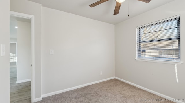 empty room with ceiling fan and light colored carpet