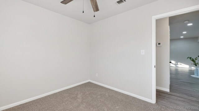 spare room with ceiling fan and carpet flooring