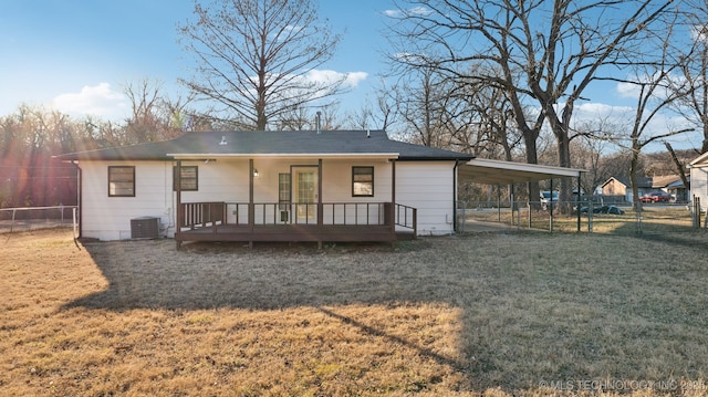 back of house featuring a yard, central AC, and a carport