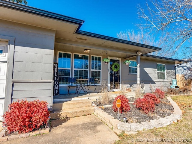 doorway to property featuring covered porch