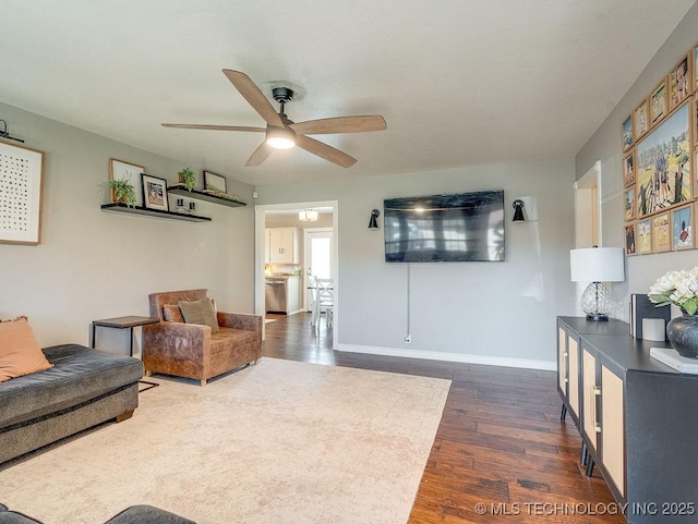 living room featuring dark hardwood / wood-style flooring and ceiling fan