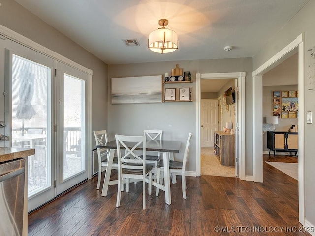 dining space featuring dark hardwood / wood-style flooring